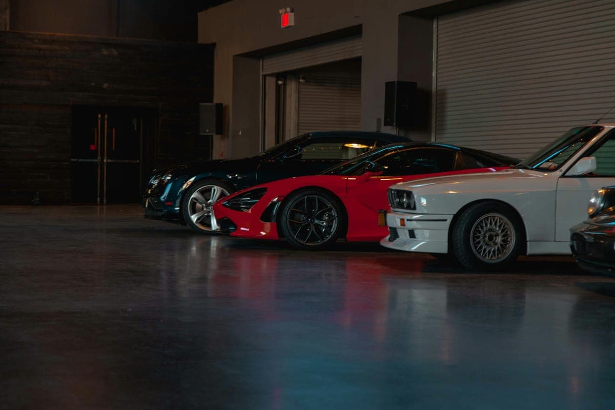 Sports cars lined up in a garage